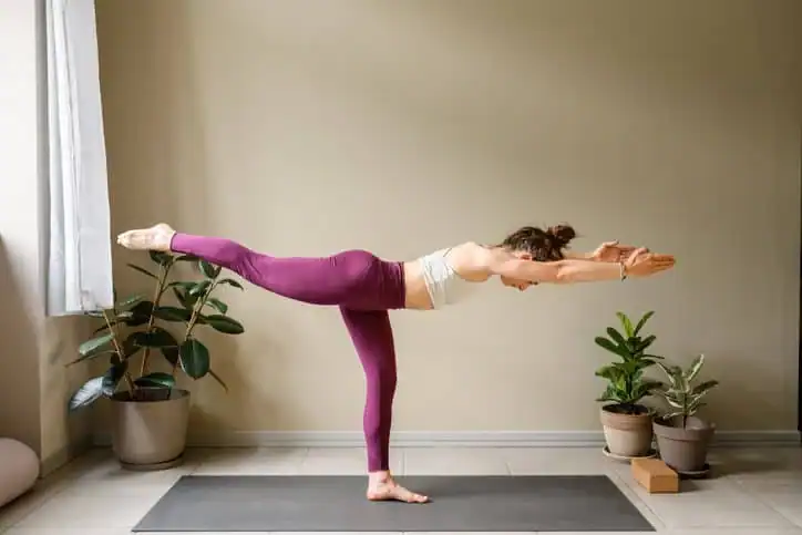 Woman doing Yoga exercise Woodley  to help with toning the body. 